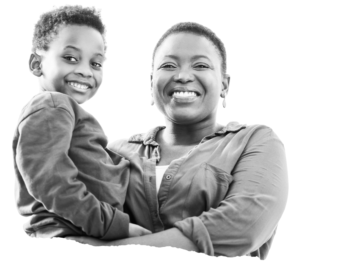 A smiling mother holding her young son, both laughing